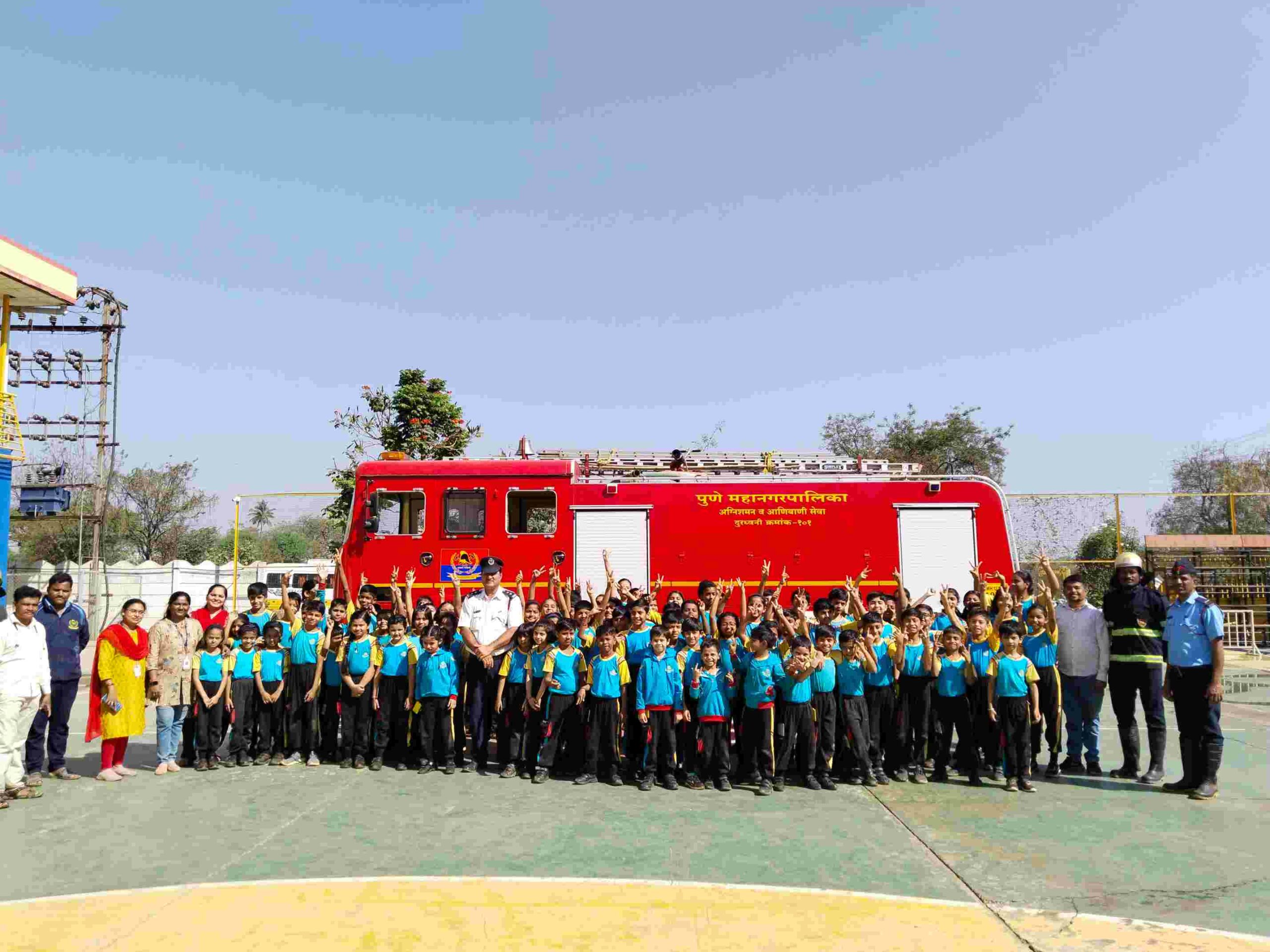 Firefighters demonstrating safety procedures to students