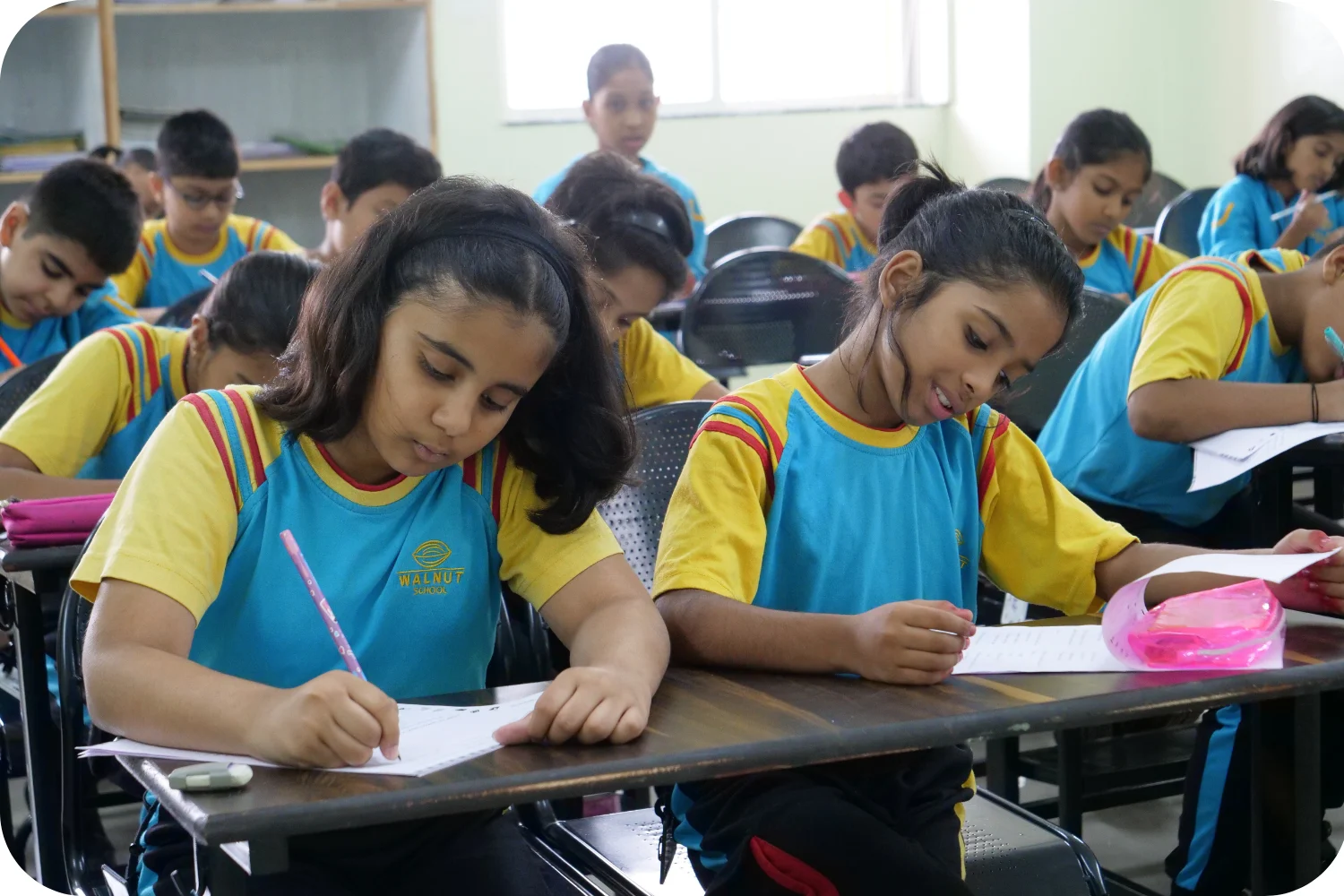 Walnut School students writing attentively during classwork session