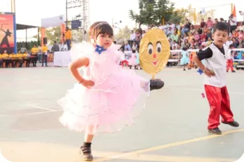 Walnut School kindergarten student performing in a colourful dance at the school carnival.